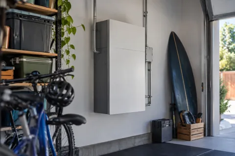 A home battery mounted in a garage
