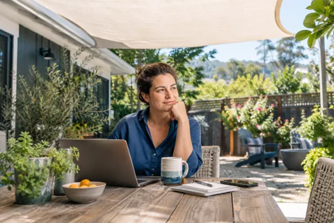 A homeowner relaxing on a shaded patio
